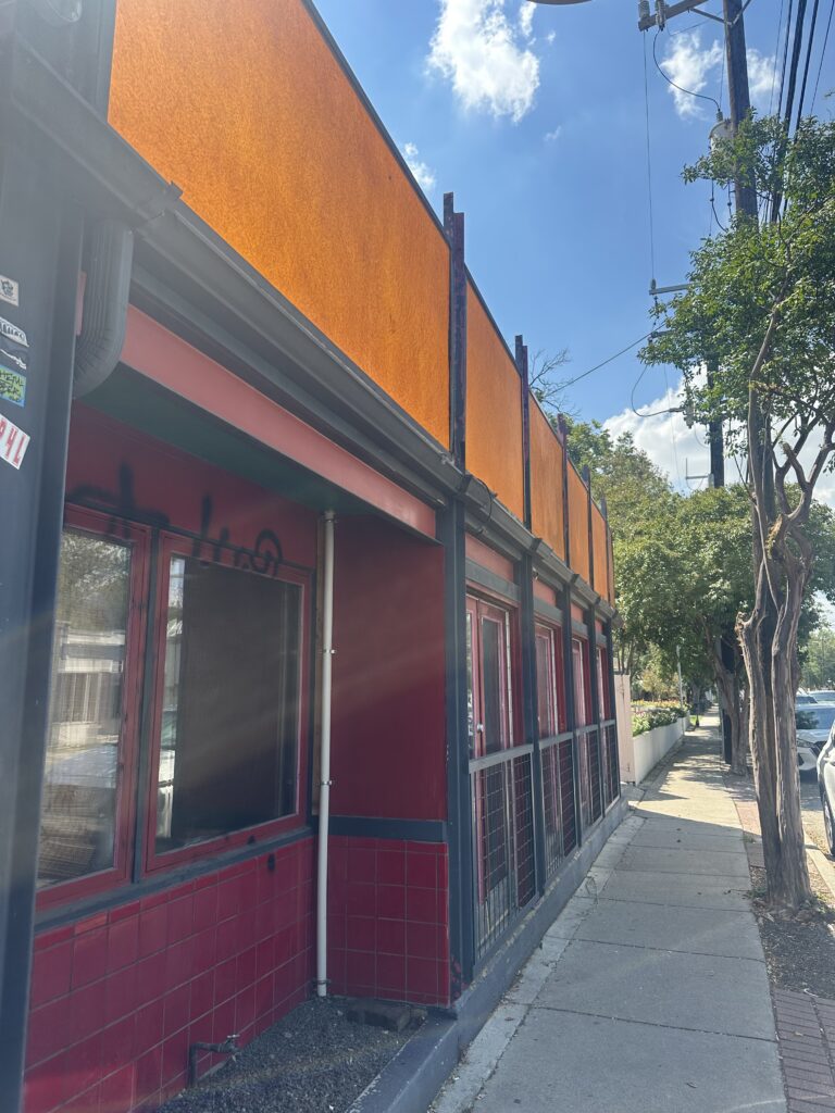 Commercial exterior painting for a restaurant with a black and white storefront renovation in San Antonio, TX