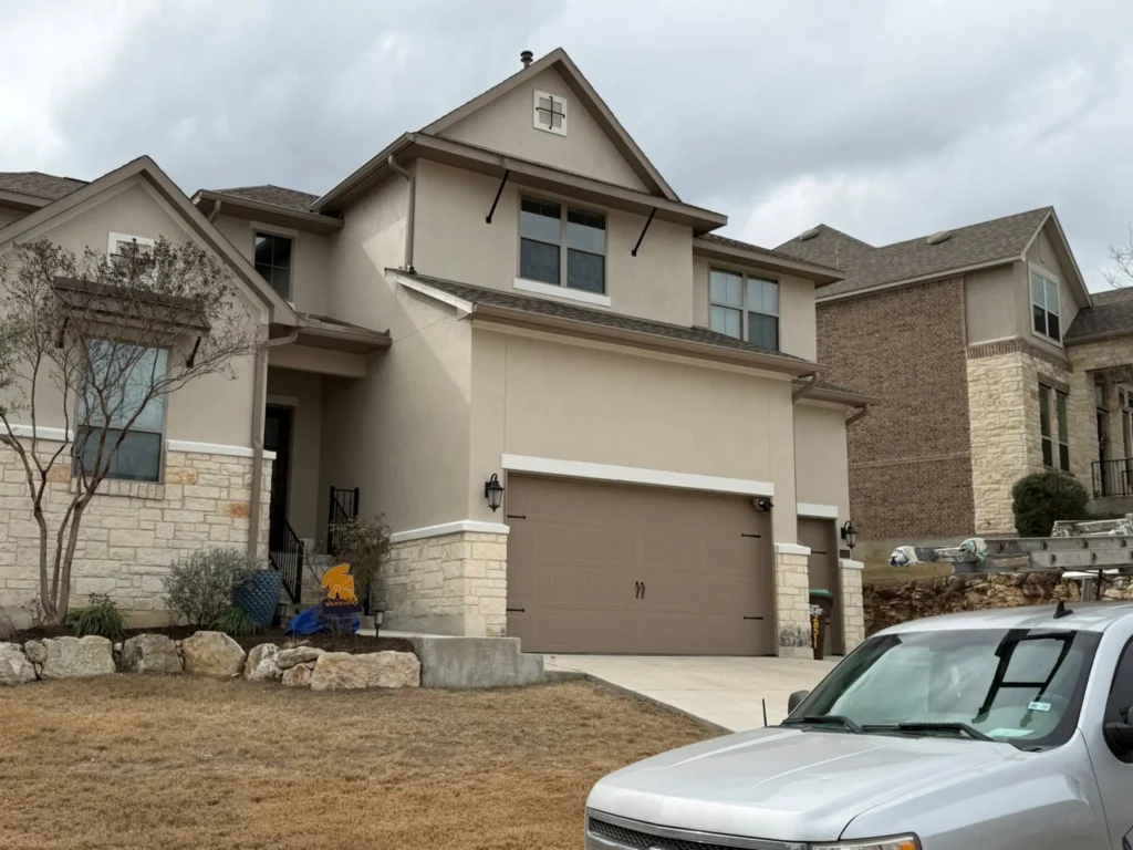 Two-story residential exterior with painted siding and trim